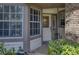 Inviting entryway with a decorative glass door, large windows, and lush landscaping at 1290 Clays Trl, Oldsmar, FL 34677