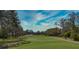 Scenic view of the well-maintained golf course, surrounded by lush trees at 1290 Clays Trl, Oldsmar, FL 34677