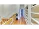 Upstairs hallway with wood floors and built in bookshelves at 1290 Clays Trl, Oldsmar, FL 34677