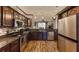 Spacious kitchen featuring stainless steel appliances, granite countertops, and a view to the living area at 1290 Clays Trl, Oldsmar, FL 34677