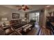 Cozy living room with leather furniture, a ceiling fan, and sliding glass doors at 1290 Clays Trl, Oldsmar, FL 34677
