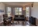Inviting living room with large windows, comfortable seating, and a stylish rug at 1290 Clays Trl, Oldsmar, FL 34677