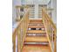 Wooden staircase with railing, open to the foyer below at 1290 Clays Trl, Oldsmar, FL 34677