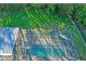 Aerial view of the screened-in pool, spa, and backyard from above at 1405 Kensington Woods Dr, Lutz, FL 33549