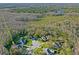 Stunning aerial view of homes in a cul-de-sac, nestled within a lush green and wooded landscape at 1405 Kensington Woods Dr, Lutz, FL 33549