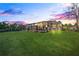 Spacious backyard with a screened-in porch and lush green lawn perfect for outdoor enjoyment at 1405 Kensington Woods Dr, Lutz, FL 33549