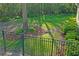 Landscaped backyard with wrought iron fence, lush lawn and mature trees at 1405 Kensington Woods Dr, Lutz, FL 33549
