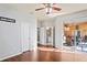 Bedroom with ensuite bathroom access, hardwood floors, and sliding glass doors to the patio at 1405 Kensington Woods Dr, Lutz, FL 33549