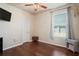 Well-lit bedroom with modern floors, ceiling fan, and a large bright window at 1405 Kensington Woods Dr, Lutz, FL 33549