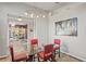 Bright dining room with a glass table, modern lighting, and stylish decor at 1405 Kensington Woods Dr, Lutz, FL 33549