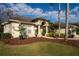 Charming front exterior with manicured landscaping, a stylish entrance, and a three-car garage at 1405 Kensington Woods Dr, Lutz, FL 33549