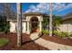Inviting front entrance with an arched portico, decorative pillars, and lush tropical foliage at 1405 Kensington Woods Dr, Lutz, FL 33549