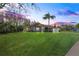 Beautifully landscaped front yard with a green lawn, mature trees, and attractive curb appeal at 1405 Kensington Woods Dr, Lutz, FL 33549