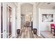 Open hallway featuring wood floors and entry to the living room and dining room at 1405 Kensington Woods Dr, Lutz, FL 33549