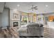 Open living room features a fireplace and large windows that look out to the pool area at 1405 Kensington Woods Dr, Lutz, FL 33549