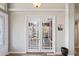 Inviting office entrance with glass french doors and a view of built-in shelves at 1405 Kensington Woods Dr, Lutz, FL 33549