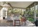 Outdoor kitchen with granite countertops, grill, and beverage cooler on covered patio at 1405 Kensington Woods Dr, Lutz, FL 33549
