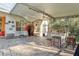 Covered patio with outdoor kitchen, lounge seating, and vintage Coca-Cola refrigerator at 1405 Kensington Woods Dr, Lutz, FL 33549