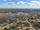 Wide aerial shot of the neighborhood near the lake, highlighting community layout at 1472 Ivydale Rd, Spring Hill, FL 34606