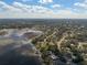 Expansive aerial view of a neighborhood near a picturesque lake at 1472 Ivydale Rd, Spring Hill, FL 34606