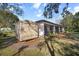 View of the back exterior with a shed at 1472 Ivydale Rd, Spring Hill, FL 34606