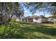 Expansive backyard featuring lush greenery, mature trees, and the rear of a well-maintained home at 1472 Ivydale Rd, Spring Hill, FL 34606