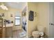 Bathroom featuring tiled floors, vanity with sink, toilet, and shower with patterned curtain at 1472 Ivydale Rd, Spring Hill, FL 34606