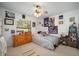 Bright bedroom featuring a large window, ceiling fan, and wall decorations at 1472 Ivydale Rd, Spring Hill, FL 34606