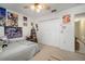 Cozy bedroom featuring a double bed, closet, and colorful posters on the walls at 1472 Ivydale Rd, Spring Hill, FL 34606