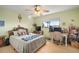 Bright bedroom with a light-colored bed, desk, and large window showcasing outdoor view at 1472 Ivydale Rd, Spring Hill, FL 34606