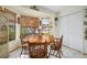 Charming breakfast nook with bay windows, a round wooden table, and a cozy atmosphere at 1472 Ivydale Rd, Spring Hill, FL 34606