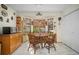 Breakfast nook with bay windows, wooden table, chairs and built-in cabinet storage at 1472 Ivydale Rd, Spring Hill, FL 34606