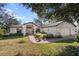 Charming single story home featuring an attached two car garage and a well manicured front lawn at 1472 Ivydale Rd, Spring Hill, FL 34606
