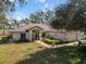 Charming single story home featuring an attached two car garage and a well manicured front lawn at 1472 Ivydale Rd, Spring Hill, FL 34606