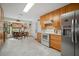 Bright kitchen with stainless steel refrigerator, tiled backsplash and breakfast nook with bay windows at 1472 Ivydale Rd, Spring Hill, FL 34606