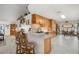 Kitchen with wood cabinets, tile backsplash, a breakfast bar, and stainless steel appliances at 1472 Ivydale Rd, Spring Hill, FL 34606