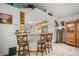Open kitchen with bar seating, seamlessly connecting to the dining and kitchen areas at 1472 Ivydale Rd, Spring Hill, FL 34606