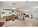 Open-concept living room showcasing a harmonious blend of flooring and comfortable furnishings at 1472 Ivydale Rd, Spring Hill, FL 34606