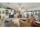 Spacious living room with bright flooring, cozy furnishings, and large glass doors at 1472 Ivydale Rd, Spring Hill, FL 34606