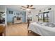 Bright main bedroom with ceiling fan, wood floors, and a view of the backyard at 1472 Ivydale Rd, Spring Hill, FL 34606