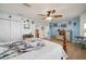 Light-filled main bedroom with a ceiling fan, wood floors, and ample closet space at 1472 Ivydale Rd, Spring Hill, FL 34606