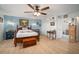 Spacious main bedroom with a ceiling fan, wood floors, and an ensuite bathroom at 1472 Ivydale Rd, Spring Hill, FL 34606