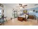 Well-lit main bedroom features a ceiling fan, wood floors and a sliding glass door with backyard views at 1472 Ivydale Rd, Spring Hill, FL 34606