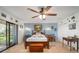 Large main bedroom with a ceiling fan, wood floors, and a sliding glass door at 1472 Ivydale Rd, Spring Hill, FL 34606