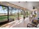 Spacious enclosed lanai with tiled floors, ceiling fans, and views of the beautifully landscaped backyard at 1472 Ivydale Rd, Spring Hill, FL 34606