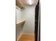 Walk-in closet featuring wooden shelves and a dark-toned cabinet for maximum storage solutions at 1811 Ridge S Rd, Largo, FL 33778