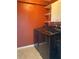 Well-equipped laundry room with modern front-load washer and dryer, featuring functional shelving and convenient layout at 1811 Ridge S Rd, Largo, FL 33778
