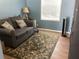 Comfortable room features a love seat, bright window and decorative rug at 1811 Ridge S Rd, Largo, FL 33778