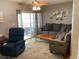Cozy living room featuring a comfortable sofa, sliding glass doors to the porch, and tasteful décor at 1811 Ridge S Rd, Largo, FL 33778