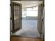 View of spacious screened-in patio through glass doors, inviting relaxation and outdoor enjoyment at 1811 Ridge S Rd, Largo, FL 33778